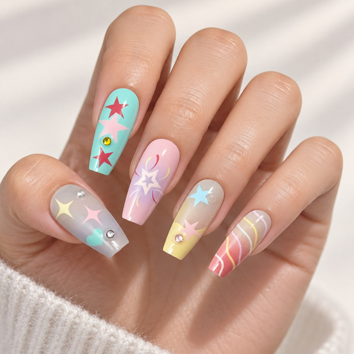 Handmade multicolour star press-on nails worn on a hand