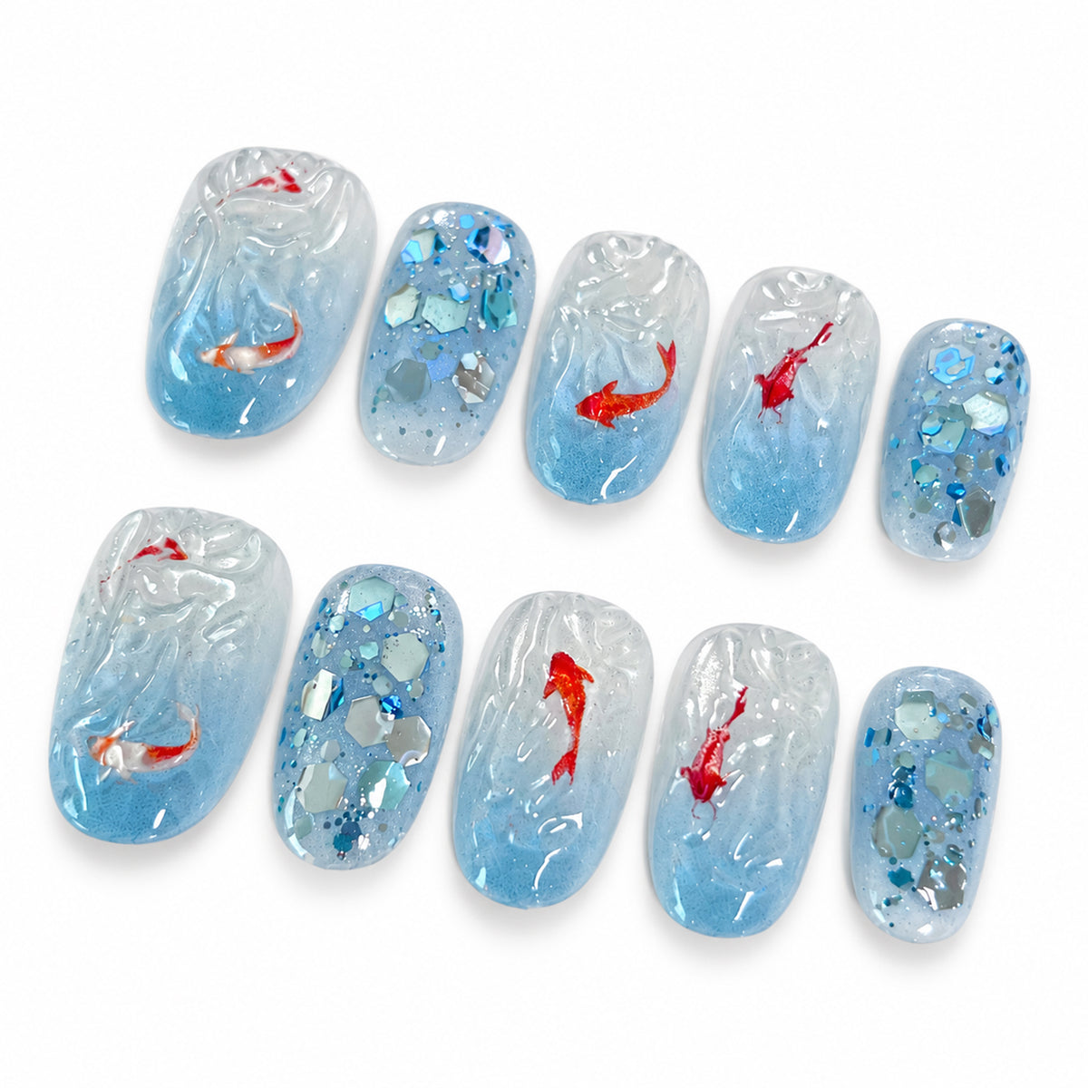Blue koi oval press-on nails with clear water-wave details, ten nail tips on a white background