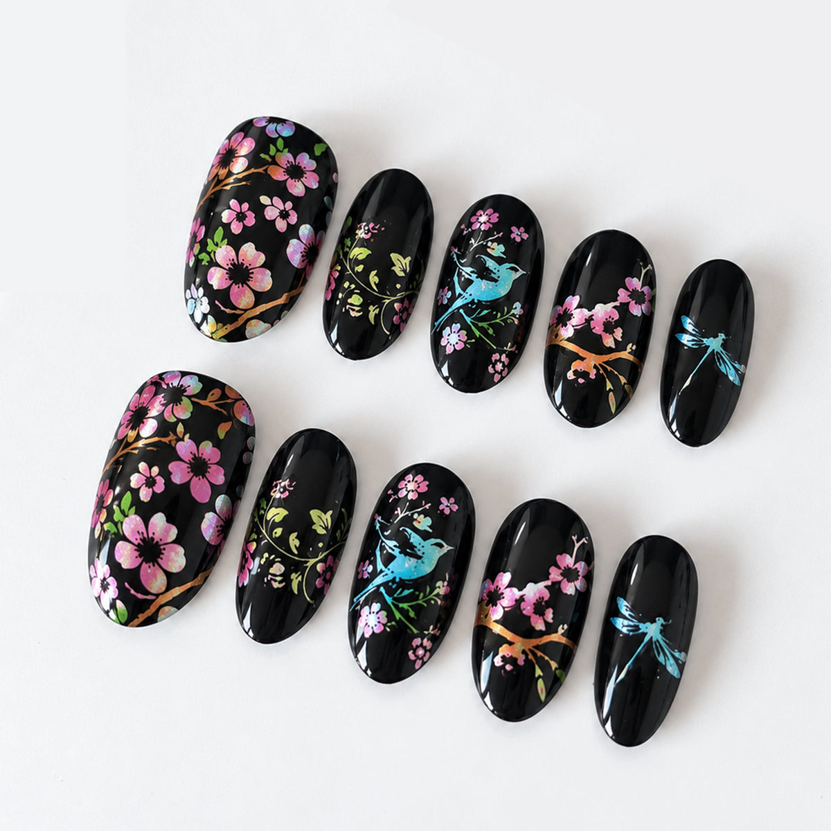 Black floral and bird oval press-on nails, ten nail tips on a white background